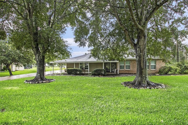 7403 Falcon Dr, Brookshire, TX 77423 - view of front of property with a front yard and brick siding