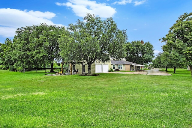 7403 Falcon Dr, Brookshire, TX 77423 - view of green lawn with an attached garage and driveway