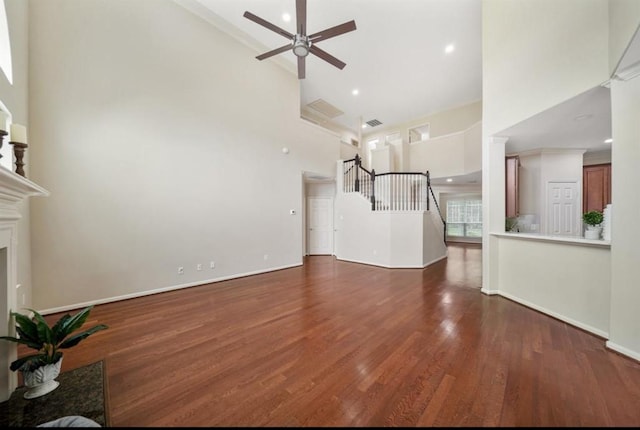 8123 Spring Bluebonnet Dr, Sugar Land, TX 77479 - unfurnished living room featuring high vaulted ceiling, a ceiling fan, wood finished floors, a fireplace, and recessed lighting