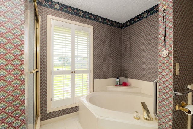 1311 Linwood Dr, Wharton, TX 77488 - bathroom with a textured ceiling, plenty of natural light, a garden tub, wallpapered walls, and a shower with shower door