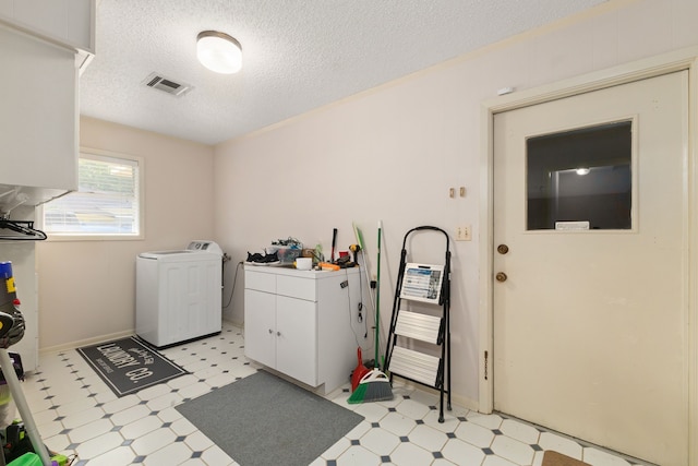 1311 Linwood Dr, Wharton, TX 77488 - laundry room with washer / dryer, light floors, a textured ceiling, and cabinet space