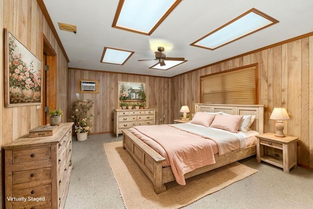 1311 Linwood Dr, Wharton, TX 77488 - bedroom with a skylight, light colored carpet, wood walls, a wall mounted air conditioner, and ceiling fan
