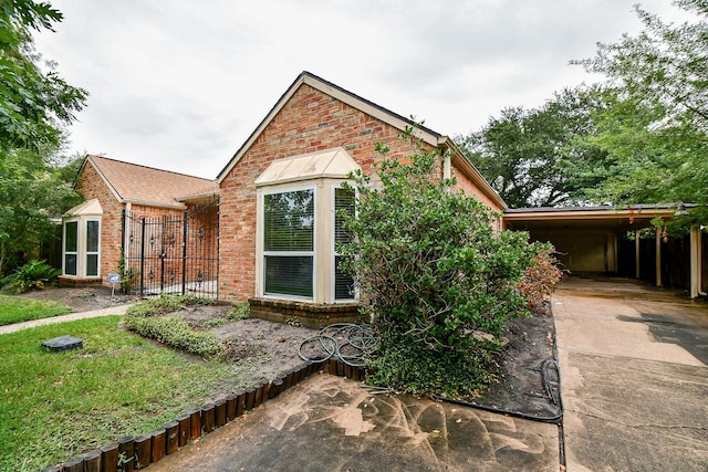 11103 Pembridge Dr, Houston, TX 77071 - view of front of house featuring brick siding, concrete driveway, and an attached carport