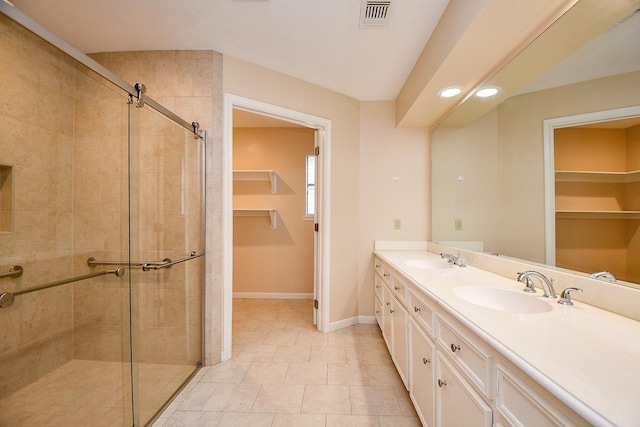 11103 Pembridge Dr, Houston, TX 77071 - full bathroom with a stall shower, double vanity, a spacious closet, and recessed lighting