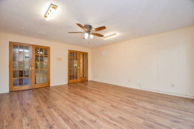11103 Pembridge Dr, Houston, TX 77071 - empty room featuring french doors, light wood-style flooring, a ceiling fan, and a textured ceiling