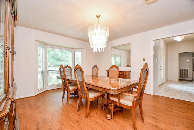 11103 Pembridge Dr, Houston, TX 77071 - dining room with light wood-style floors and a chandelier