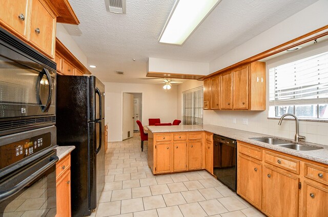 11103 Pembridge Dr, Houston, TX 77071 - kitchen featuring black appliances, a peninsula, ceiling fan, and light countertops