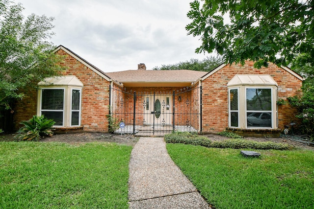 11103 Pembridge Dr, Houston, TX 77071 - view of front of home with a front lawn, brick siding, and a chimney