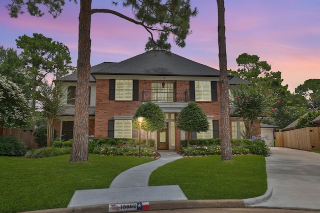 15902 Ivy Bridge Ln, Houston, TX 77095 - colonial inspired home with a balcony, brick siding, concrete driveway, and a garage