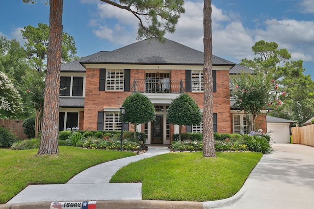 15902 Ivy Bridge Ln, Houston, TX 77095 - colonial home with a balcony, brick siding, a shingled roof, a garage, and driveway
