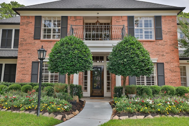 15902 Ivy Bridge Ln, Houston, TX 77095 - view of front of home featuring a balcony, brick siding, and roof with shingles