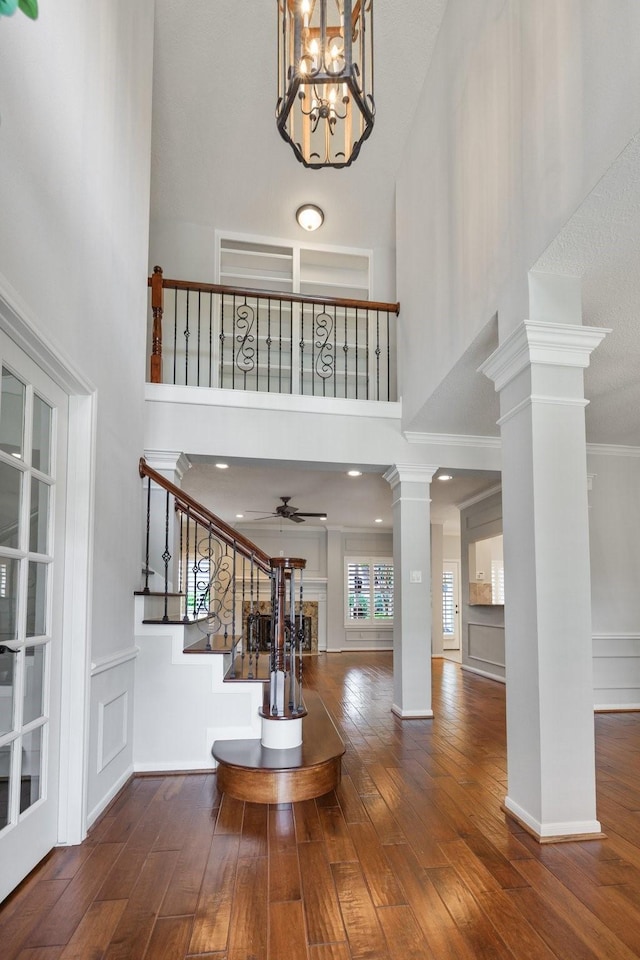 15902 Ivy Bridge Ln, Houston, TX 77095 - entrance foyer with decorative columns, stairs, hardwood / wood-style flooring, a towering ceiling, and ceiling fan