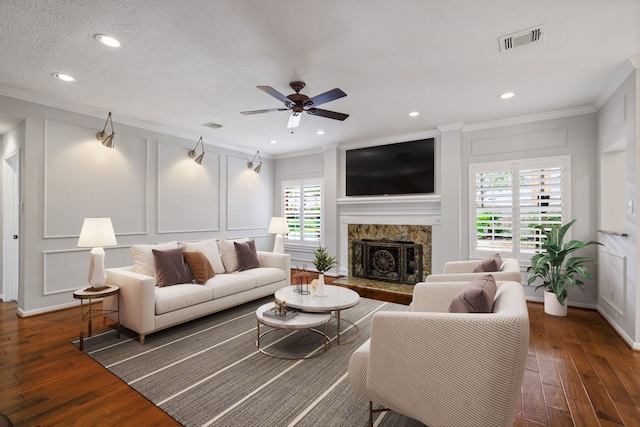 15902 Ivy Bridge Ln, Houston, TX 77095 - living area with a decorative wall, ornamental molding, hardwood / wood-style flooring, ceiling fan, and a stone fireplace