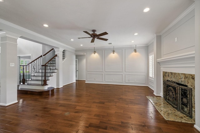 15902 Ivy Bridge Ln, Houston, TX 77095 - unfurnished living room featuring a ceiling fan, decorative columns, hardwood / wood-style floors, a premium fireplace, and ornamental molding