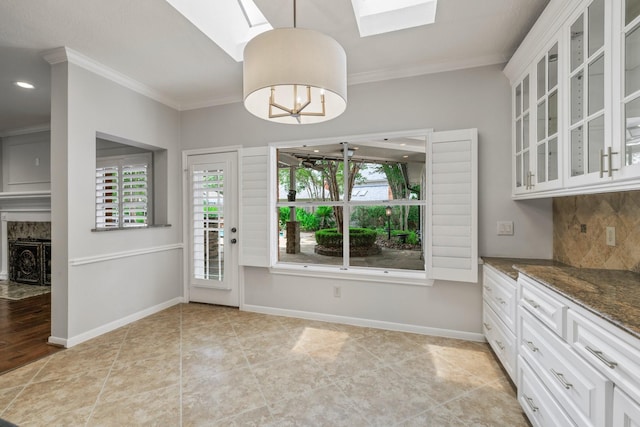 15902 Ivy Bridge Ln, Houston, TX 77095 - unfurnished dining area with a skylight, ornamental molding, and recessed lighting