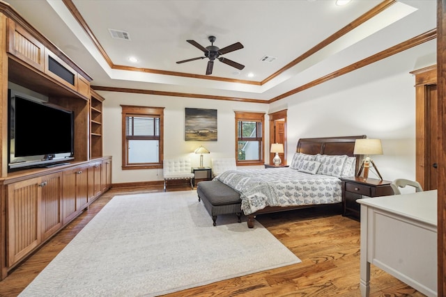 4132 Coleridge St, Houston, TX 77005 - bedroom with a raised ceiling, crown molding, light wood-style floors, ceiling fan, and recessed lighting