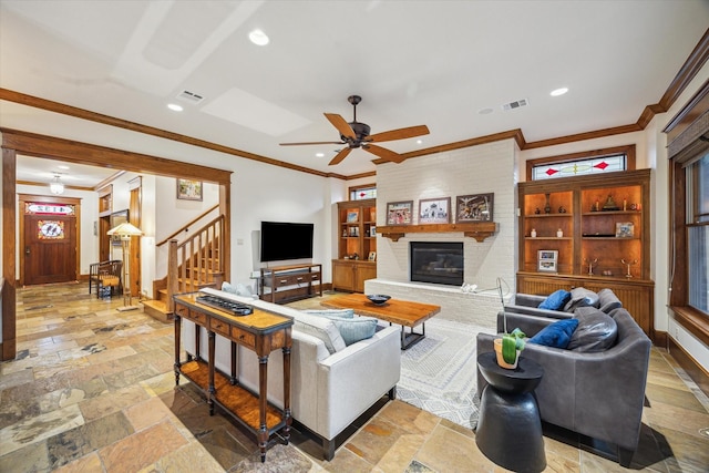 4132 Coleridge St, Houston, TX 77005 - living room featuring stairs, a fireplace, ornamental molding, a ceiling fan, and recessed lighting