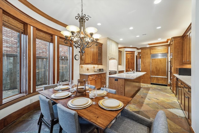 4132 Coleridge St, Houston, TX 77005 - dining area with stone tile floors, crown molding, recessed lighting, plenty of natural light, and a chandelier