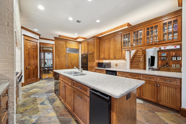 4132 Coleridge St, Houston, TX 77005 - kitchen featuring stone tile flooring, ornamental molding, a center island with sink, black appliances, and recessed lighting