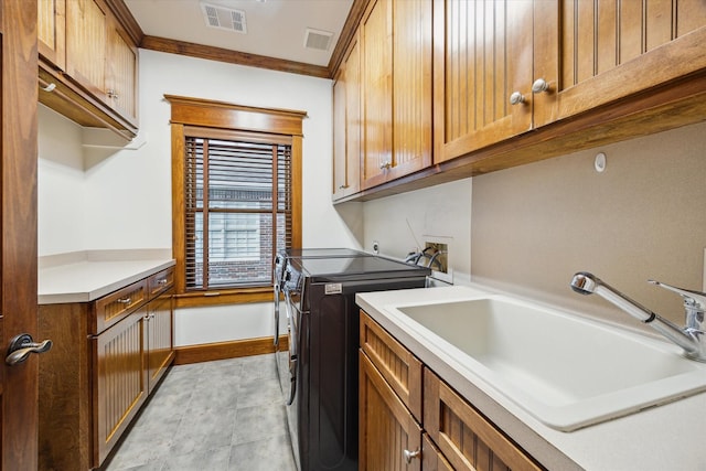 4132 Coleridge St, Houston, TX 77005 - laundry room with cabinet space, separate washer and dryer, and ornamental molding