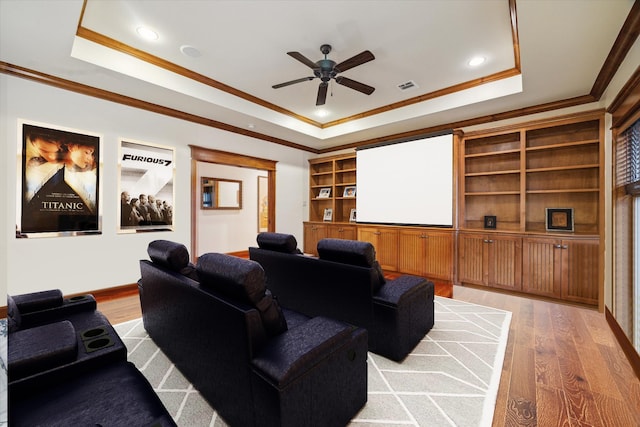 4132 Coleridge St, Houston, TX 77005 - cinema with a raised ceiling, ceiling fan, light wood-style flooring, ornamental molding, and recessed lighting
