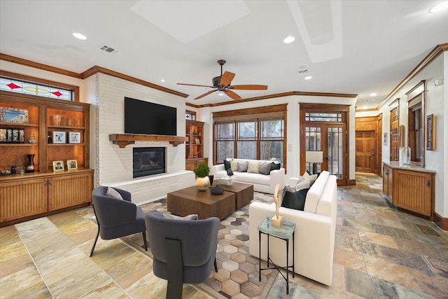4132 Coleridge St, Houston, TX 77005 - living room with crown molding, recessed lighting, a fireplace, ceiling fan, and stone tile floors