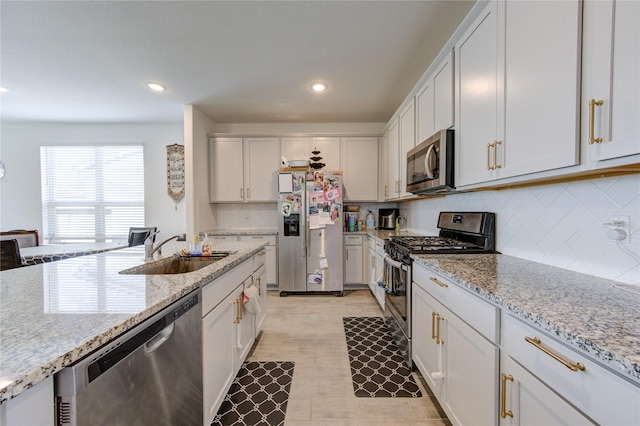 5723 Morning Vista Rd, Katy, TX 77493 - kitchen featuring stainless steel appliances, recessed lighting, light stone counters, tasteful backsplash, and light wood-type flooring