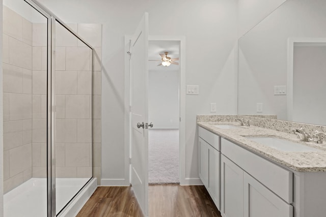 25408 Blossom Ct, Montgomery, TX 77316 - full bathroom featuring a ceiling fan, a stall shower, double vanity, and wood finished floors