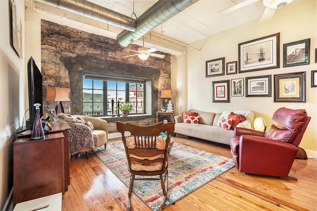 104 Moody Ave Unit 313, Galveston, TX 77550 - living room with a ceiling fan, wood-type flooring, and a towering ceiling