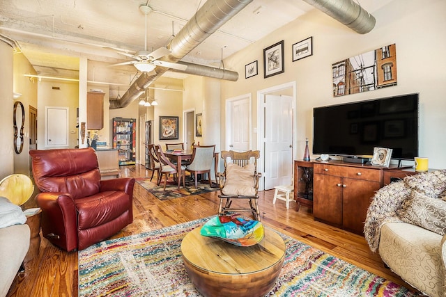 104 Moody Ave Unit 313, Galveston, TX 77550 - living area featuring light wood-type flooring, ceiling fan, a towering ceiling, and beamed ceiling