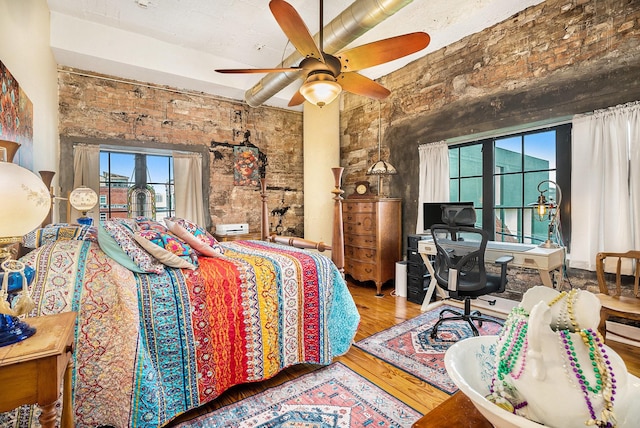 104 Moody Ave Unit 313, Galveston, TX 77550 - bedroom featuring wood finished floors, a desk, and ceiling fan