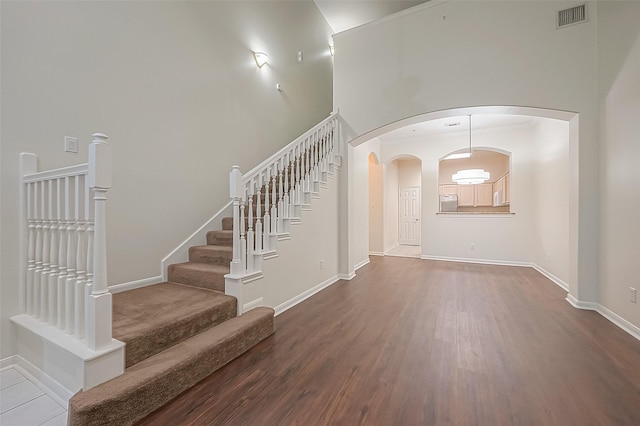 2710 Grants Lake Blvd Unit T6, Sugar Land, TX 77479 - staircase featuring arched walkways, wood finished floors, and a high ceiling
