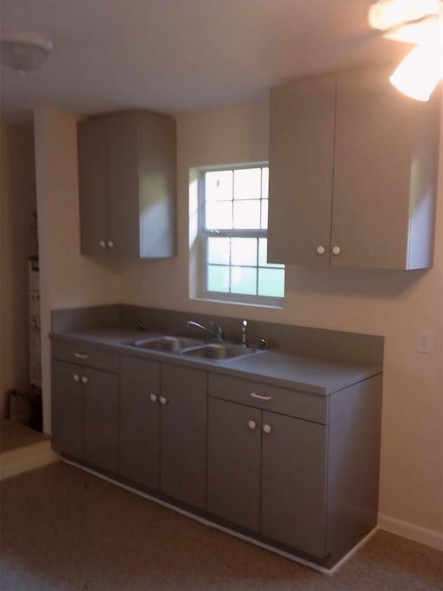 1204 Johnston St, Houston, TX 77022 - kitchen featuring a sink and baseboards