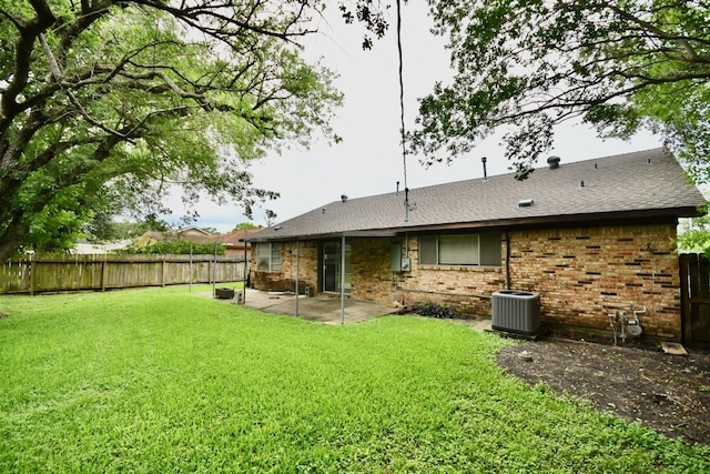 11931 Tanager St, Houston, TX 77072 - back of property featuring a fenced backyard, a patio, brick siding, and roof with shingles
