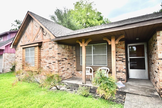 11931 Tanager St, Houston, TX 77072 - doorway to property with brick siding, roof with shingles, and a lawn