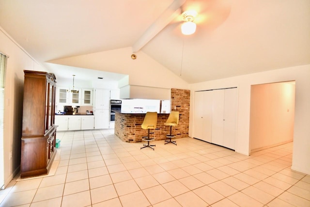 11931 Tanager St, Houston, TX 77072 - kitchen featuring beam ceiling, ceiling fan, white cabinetry, stainless steel double oven, and glass insert cabinets