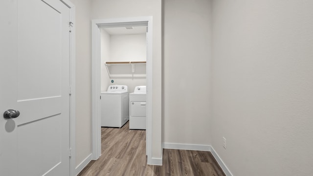 25021 Pomegranate Pl, Montgomery, TX 77316 - corridor featuring washing machine and clothes dryer and wood finished floors