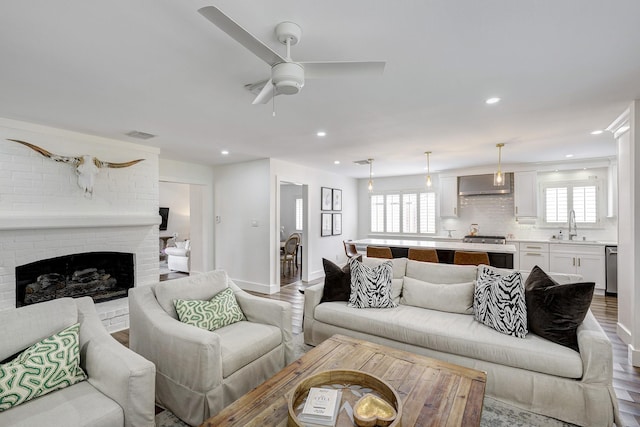 918 N Wilcrest Dr, Houston, TX 77079 - living room with recessed lighting, ceiling fan, a brick fireplace, and wood finished floors