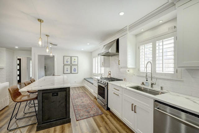 918 N Wilcrest Dr, Houston, TX 77079 - kitchen featuring stainless steel appliances, exhaust hood, backsplash, light stone countertops, and recessed lighting
