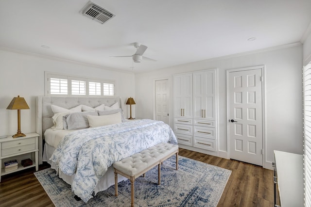 918 N Wilcrest Dr, Houston, TX 77079 - bedroom featuring ornamental molding, dark wood-style floors, a ceiling fan, and two closets