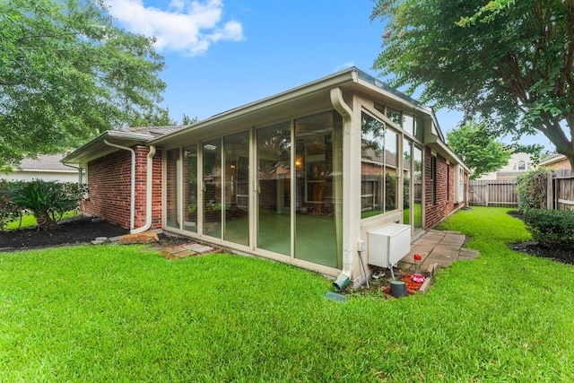 24910 Corbin Gate Dr, Spring, TX 77389 - view of home's exterior featuring brick siding and a sunroom