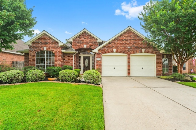 24910 Corbin Gate Dr, Spring, TX 77389 - traditional-style home with a garage, brick siding, a front yard, and driveway