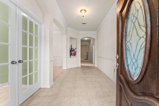 24910 Corbin Gate Dr, Spring, TX 77389 - entrance foyer with arched walkways, ornamental molding, and light tile patterned floors
