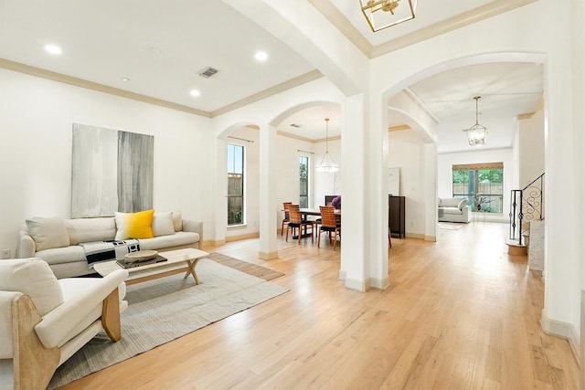 4106 Lehigh Ave, Houston, TX 77005 - living area with arched walkways, a chandelier, crown molding, light wood-type flooring, and recessed lighting