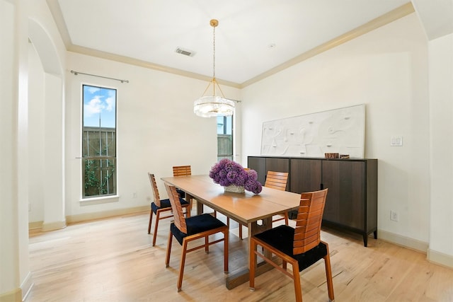 4106 Lehigh Ave, Houston, TX 77005 - dining area with light wood-style floors, arched walkways, a chandelier, and crown molding