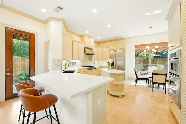 4106 Lehigh Ave, Houston, TX 77005 - kitchen featuring appliances with stainless steel finishes, under cabinet range hood, a center island, decorative backsplash, and a breakfast bar area