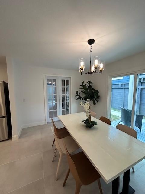1635 Chippendale Rd, Houston, TX 77018 - dining space featuring a chandelier and light tile patterned floors