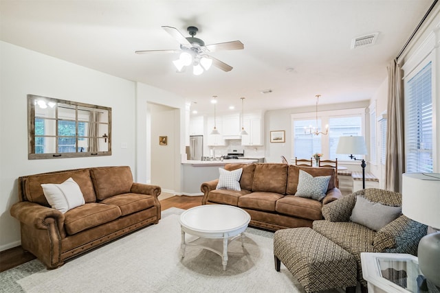 703 Rock Creek Ct, Rosenberg, TX 77469 - living area with wood finished floors, ceiling fan, and a chandelier
