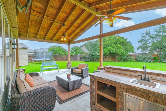 703 Rock Creek Ct, Rosenberg, TX 77469 - fenced backyard with a trampoline, a ceiling fan, area for grilling, and a patio area