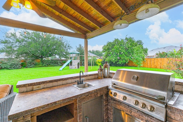 703 Rock Creek Ct, Rosenberg, TX 77469 - fenced backyard with a playground and an outdoor kitchen